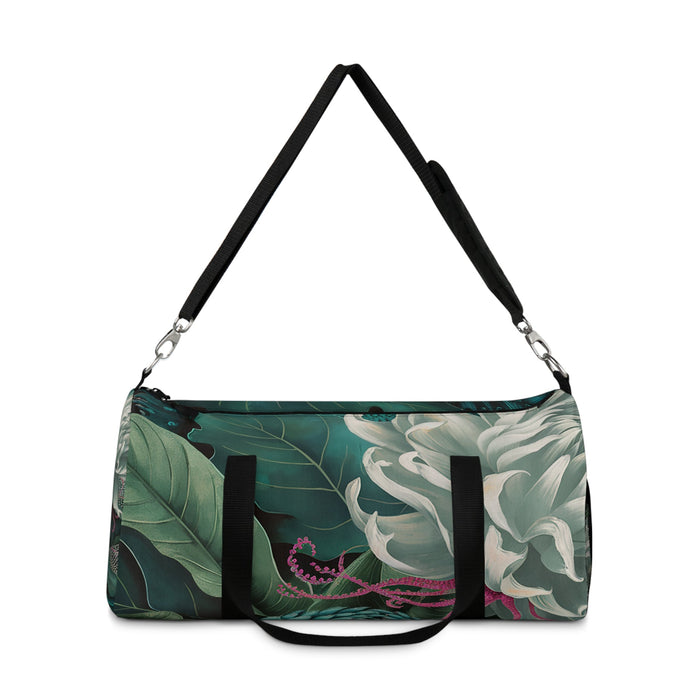 Green botanical duffel bag with shoulder strap, black webbing trim, and zip top
