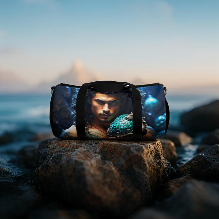 Blue dragon-egg duffel bag with black top handle and front portrait artwork.