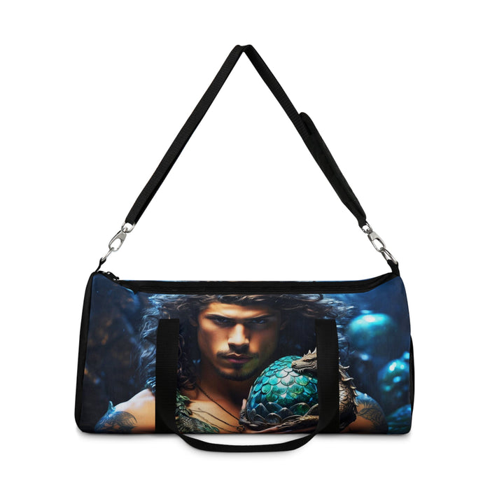 Blue dragon-egg duffel bag with black crossbody straps and front portrait panel.