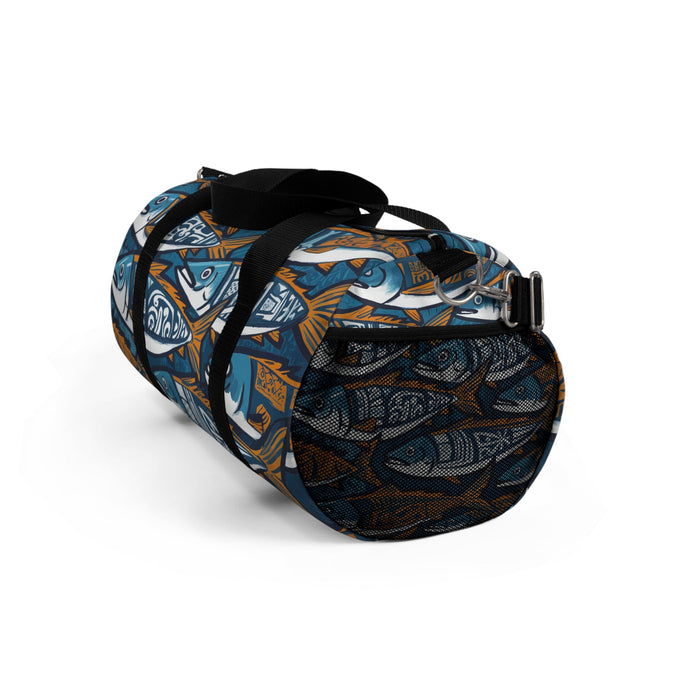 Fish print duffel bag with black webbing straps and a metal D-ring, blue and orange.