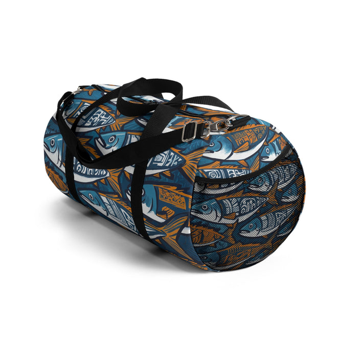 Fish print duffel bag with black shoulder strap and metal buckle detail, blue and orange.