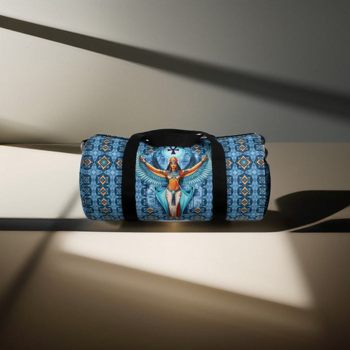 Blue duffel bag with black end straps and centered Isis goddess winged artwork