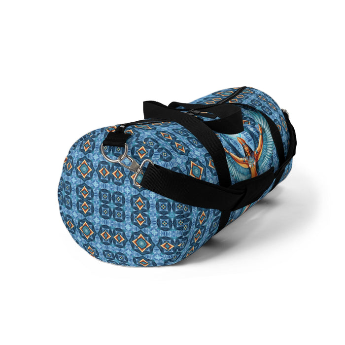 Blue duffel bag angled view with black strap and Isis goddess winged panel