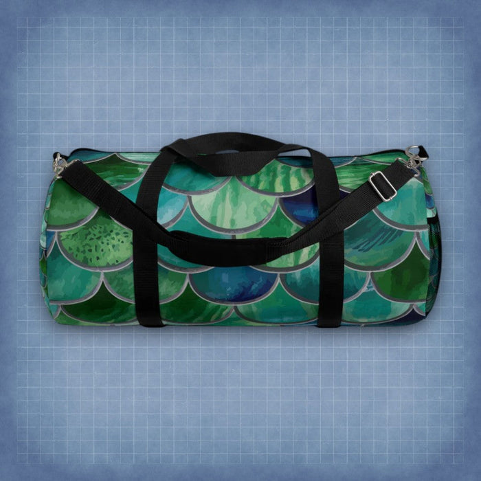 Mermaid-scale duffel bag with black straps and silver zipper pulls
