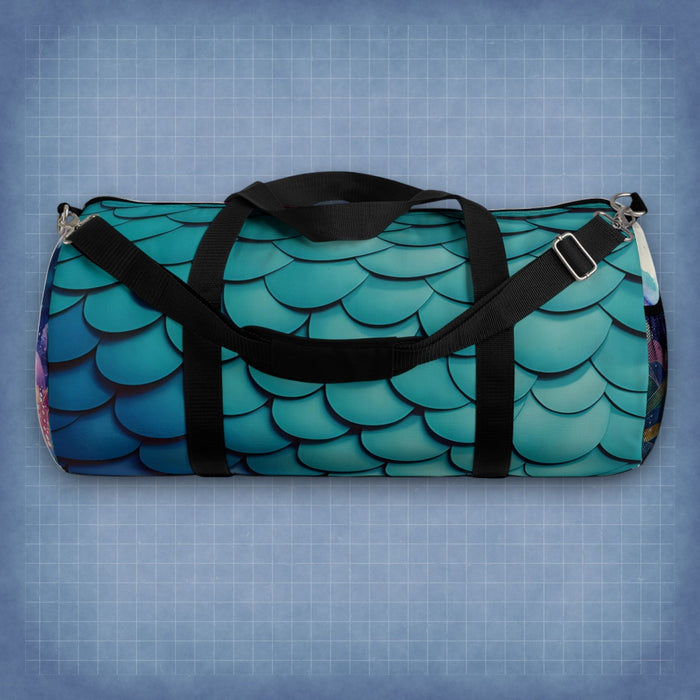 Teal mermaid-scales duffel bag with black webbing straps and metal zipper pulls.