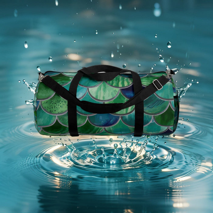 Green mermaid-scale duffel bag with black straps and silver hardware