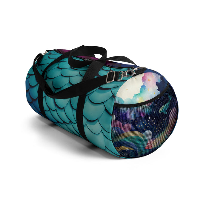 Teal mermaid-scales duffel bag with a black strap and galaxy-pattern end panel.