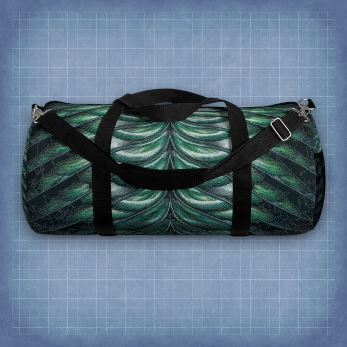 Merman scales duffel bag with black handles and shoulder strap, green-blue shell pattern.