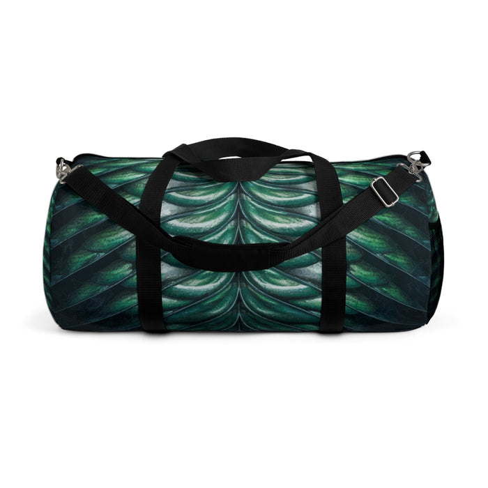 Merman scales duffel bag with black top handles and end buckles, green-blue shell print.