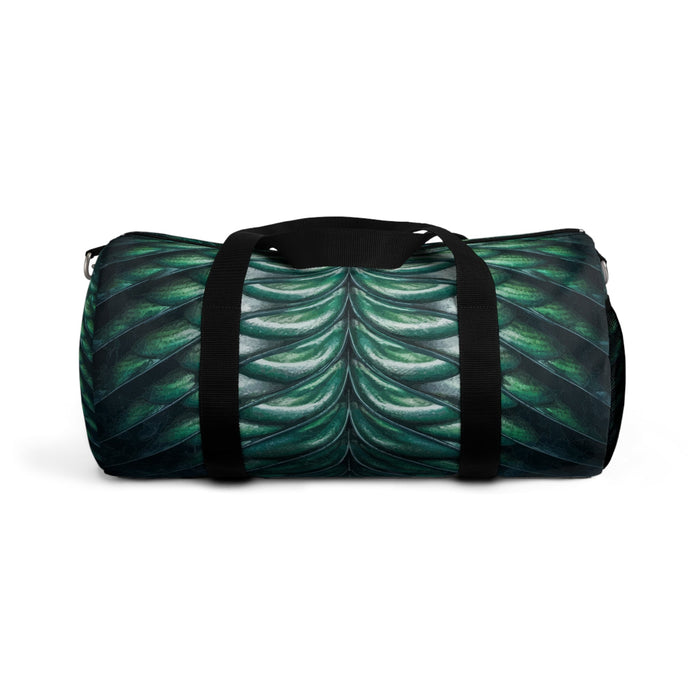 Merman scales duffel bag side view, black straps and green-blue shell scale pattern.