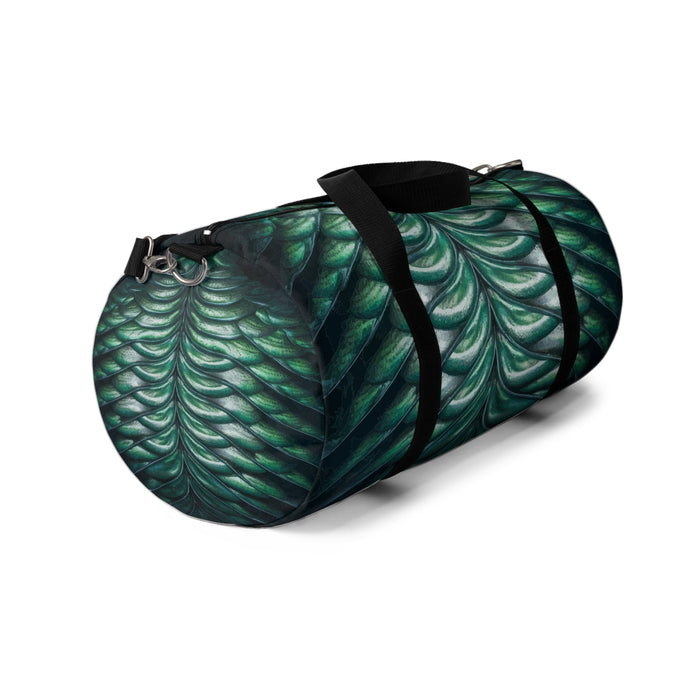 Merman scales duffel bag end view with zipper pulls and black shoulder strap, green-blue scales.
