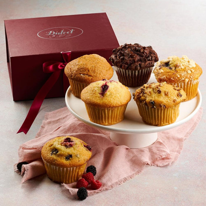 Fresh baked muffin assortment on a plate with chocolate and berry muffins