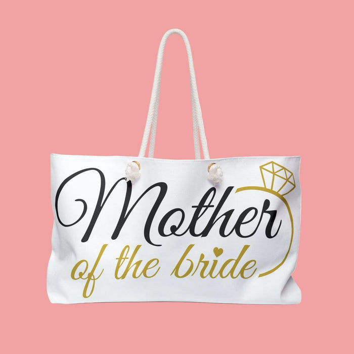 White tote bag with "Mother of the Bride" text, gold diamond icon, and fabric handles
