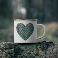 White enamel camping mug with teal mermaid heart graphic on front and right handle
