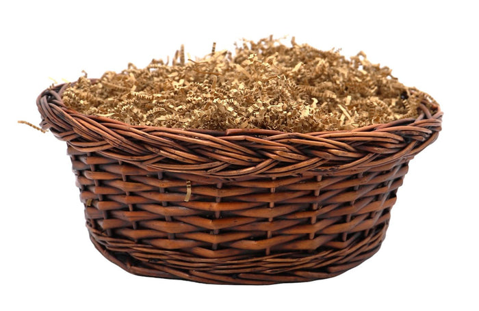 Woven wicker gift basket with shredded filler, no items inside