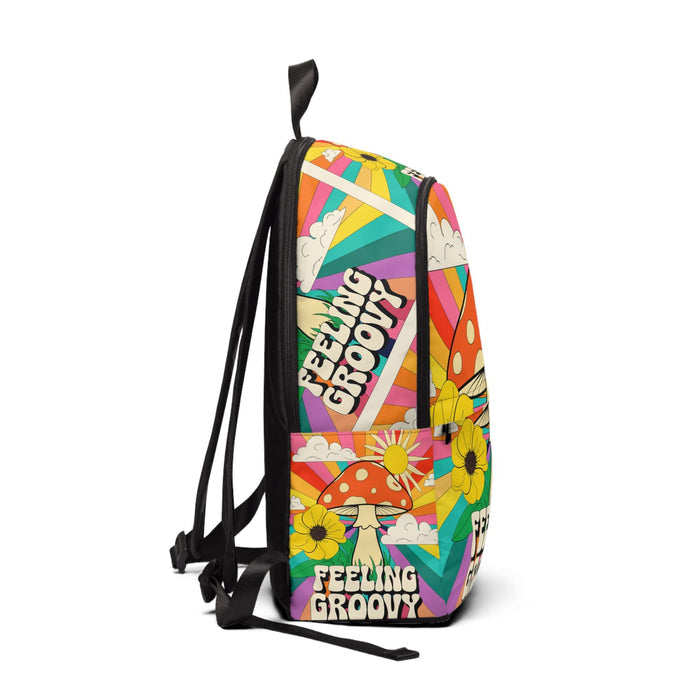 Colorful fabric backpack, side view with shoulder straps, bold text and floral mushroom graphics.