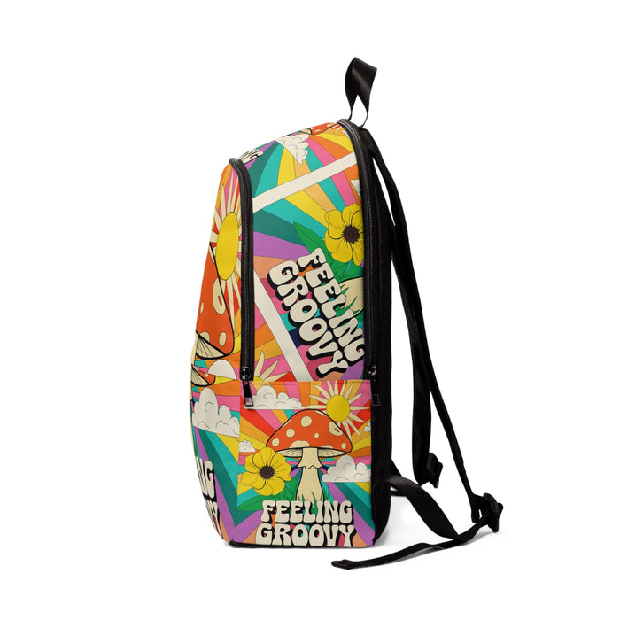 Colorful fabric backpack, back view with straps, mushroom, sun, and flower graphic print.