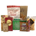 Green Christmas gift basket with assorted gourmet snack packages and treats