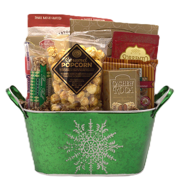 Green Christmas basket with assorted candy and snack packages, snowflake design