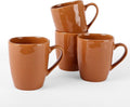 Brown stoneware coffee mug set of four with glossy reactive glaze, side handles visible