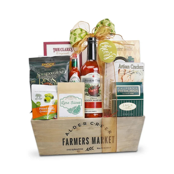 Cocktail gift basket in wooden crate with bow, bottles, crackers, olives, mixing ingredients
