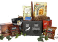 Wicker gift basket holding assorted packaged snacks, crackers, and soup mixes