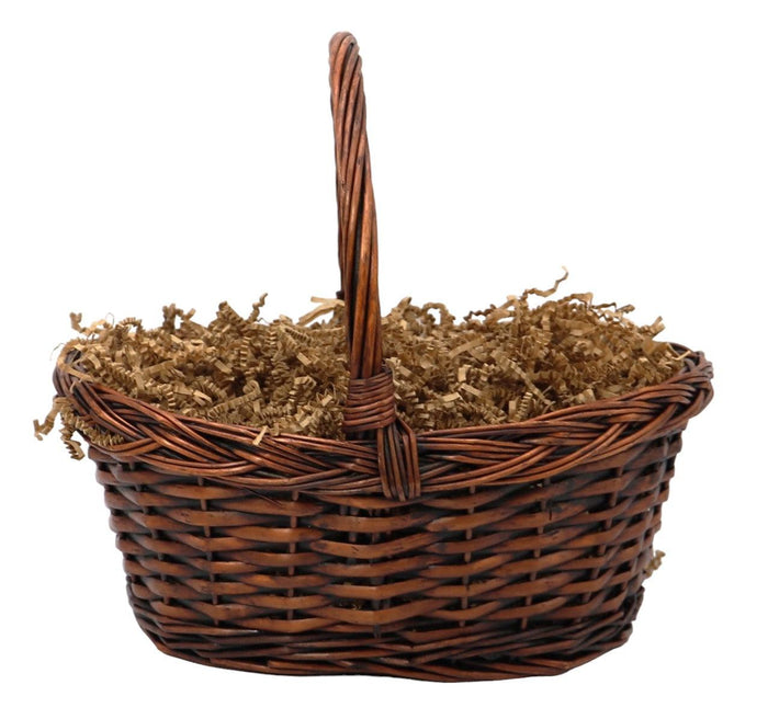 Woven wicker gift basket with handle, filled with gourmet food items