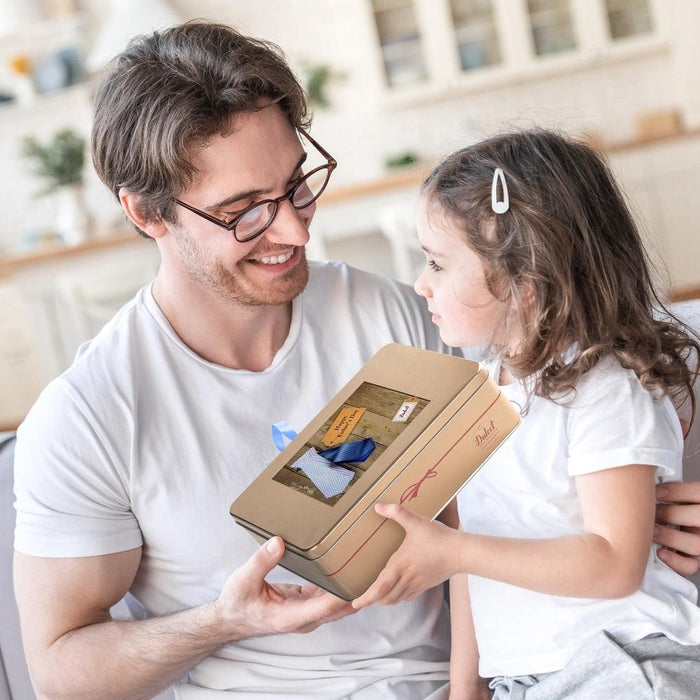 Gourmet tin gift held by a man and child in white shirts