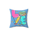 Square faux suede pillow with light blue print: pink teacher, pencil, books, globe, teal alphabet