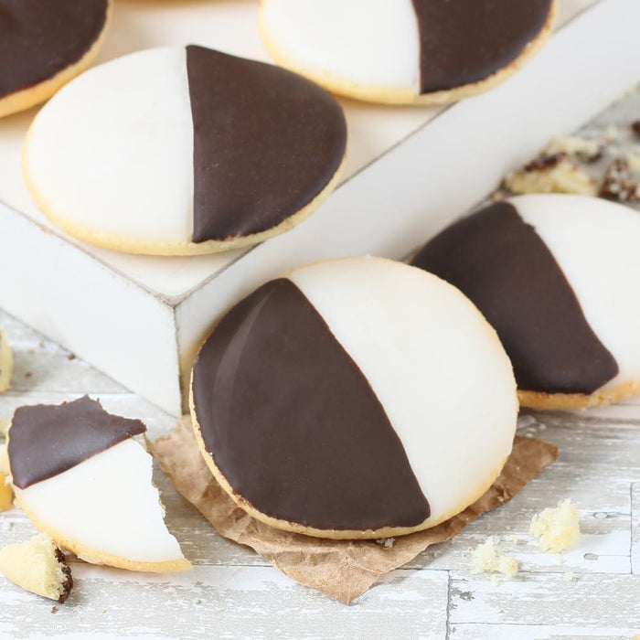 Black and white sugar cookies with chocolate and vanilla icing, close-up