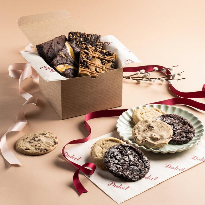 Gourmet cookie and brownie gift box with assorted treats, ribbon, and paper liner