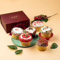 Festive holiday cupcakes on a green plate, frosted with red and green sprinkles