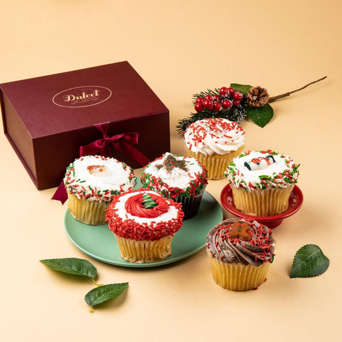 Festive holiday cupcakes on a green plate, frosted with red and green sprinkles