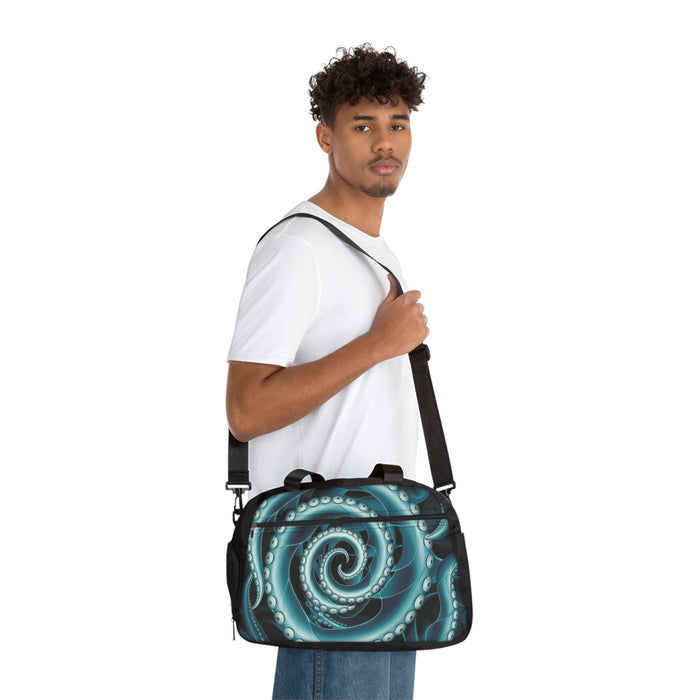 Fitness handbag worn crossbody, teal octopus swirl print with black shoulder strap