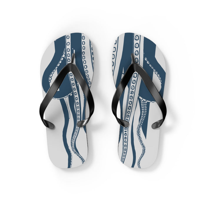 Pair of blue octopus-pattern flip-flops with black straps on light background