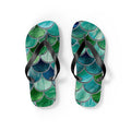 Mermaid-scale flip flops, black straps over teal, blue, and green scale print