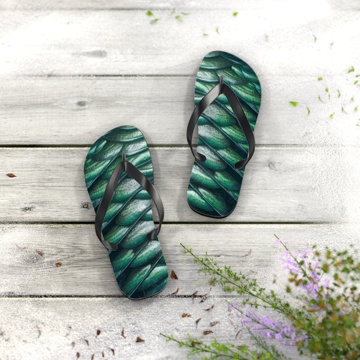 Green merman scales flip flops on light boards; black thong straps