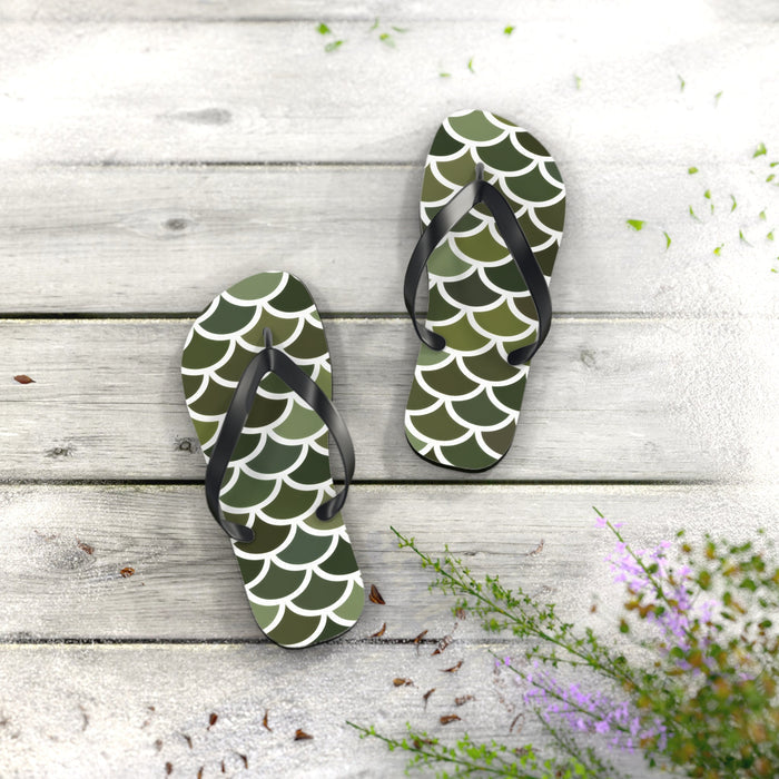 Green flip-flops with white scale pattern and black thong straps, standing upright