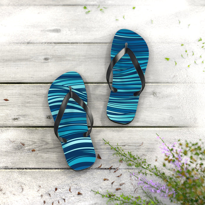 Blue ocean-wave flip flops with black straps and textured non-slip sole