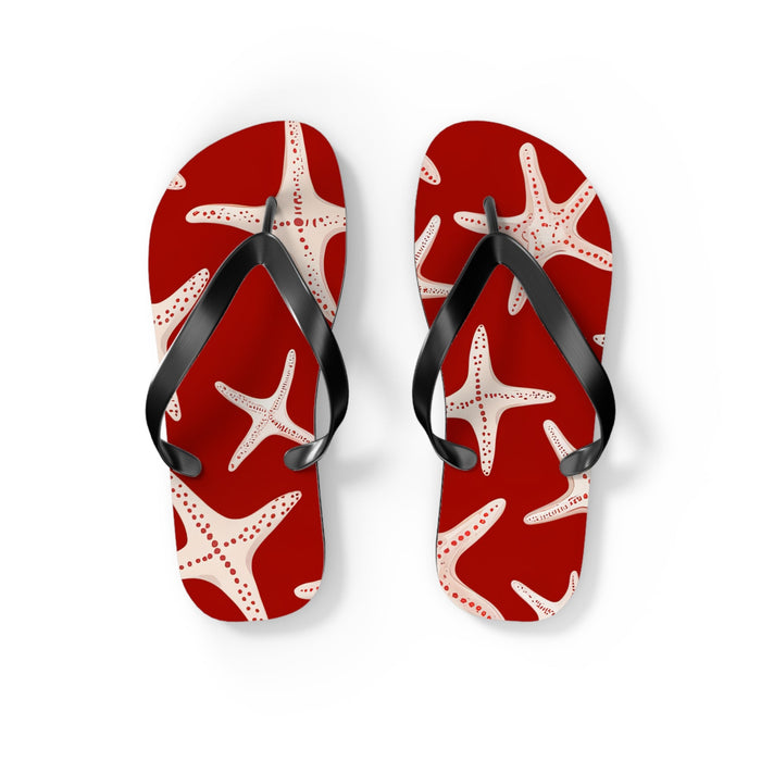 Red flip flops with white starfish print and black thong straps