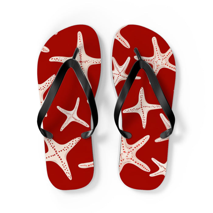 Red starfish flip flops with black thong straps, angled pair view