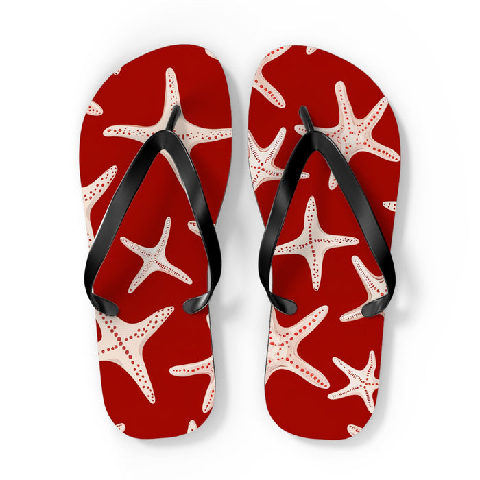 Red flip flops with white starfish print and black thong straps, front view