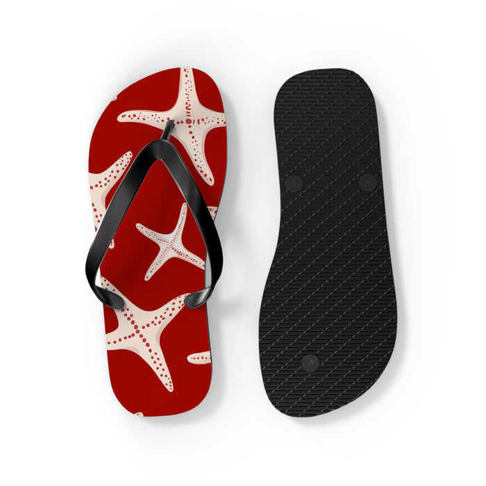 Red starfish flip flops with black textured outsole and black thong straps