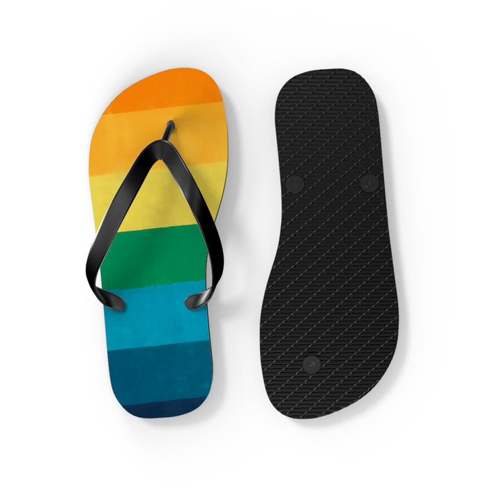 Striped flip flops with one black textured outsole and one rainbow upper sandal
