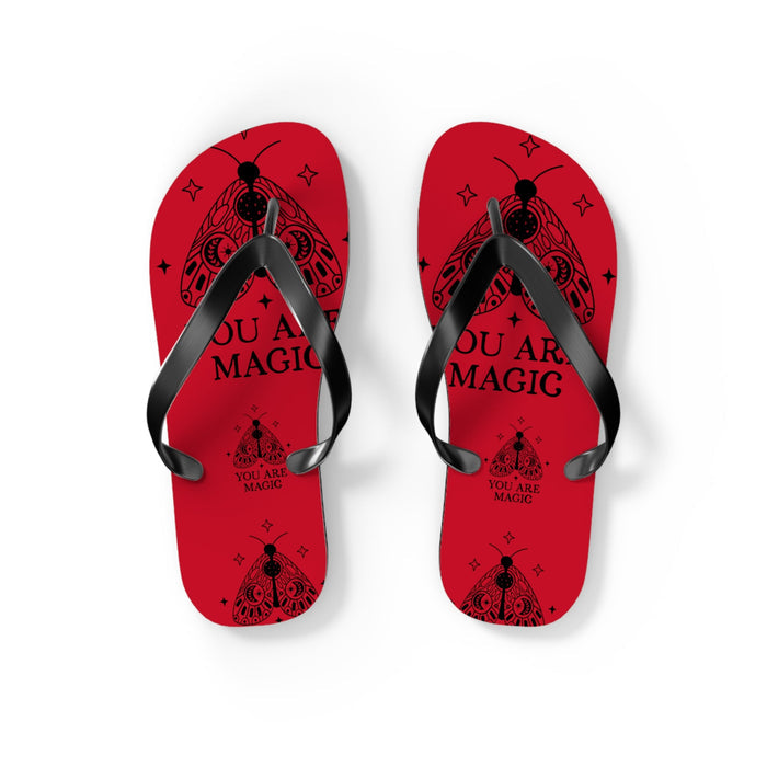 Two red flip flops with black straps, 'YOU ARE MAGIC' on inner footbeds