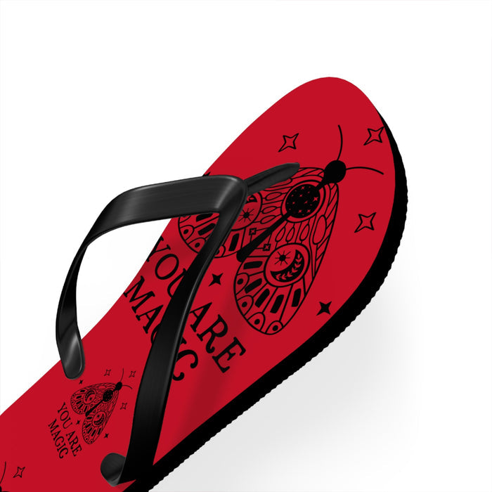 Red flip-flops with black thong straps and patterned red footbed, black sole