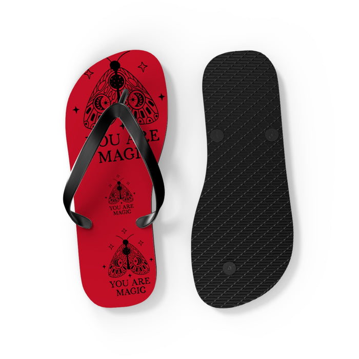 Red flip-flops showing black textured sole and patterned red top footbed