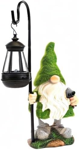 Standing green gnome statue holding black solar lantern stake light, garden ornament