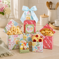 Floral gift tower with stacked patterned treat boxes, blue bow ribbon, assorted snacks