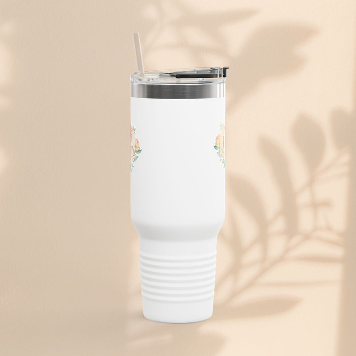 White insulated travel mug with small floral accents, clear lid and straw